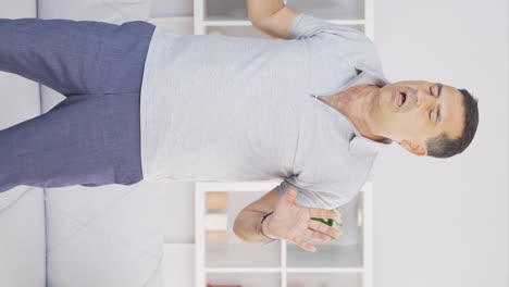 Vertical-video-of-Old-man-looking-at-laptop-with-fearful-eyes.